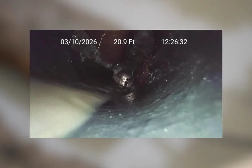 A cast iron drain or sewer pipe shows corrosion, scale, or repair work near Long Beach, CA on Plumber in Long Beach, CA