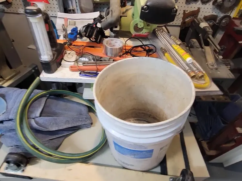 Drain cleaning equipment is used at a pipe access point to clear buildup near Cerritos, CA on Drain Cleaning & Unclogging in Cerritos, CA body dc 002