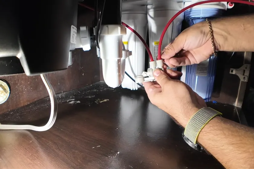Under sink disposal wiring and drain connections are checked below the kitchen basin near Cerritos, CA on Garbage Disposal Repair & Installation in Cerritos, CA faq gdr 003