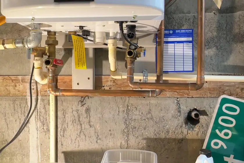 A tankless water heater connection is inspected during installation or service near Cerritos, CA on Tankless Water Heater Services in Cerritos, CA faq tl 003