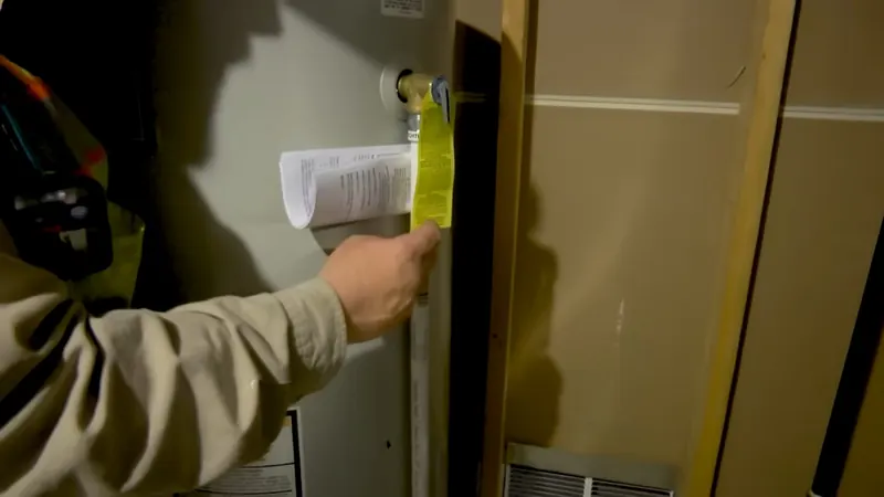 A technician documents water heater connections during inspection near Cerritos, CA on Plumbing Services in Cerritos, CA final home 005