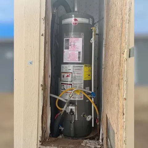 A technician documents water heater connections during inspection near Cerritos, CA on Plumbing Services in Cerritos, CA